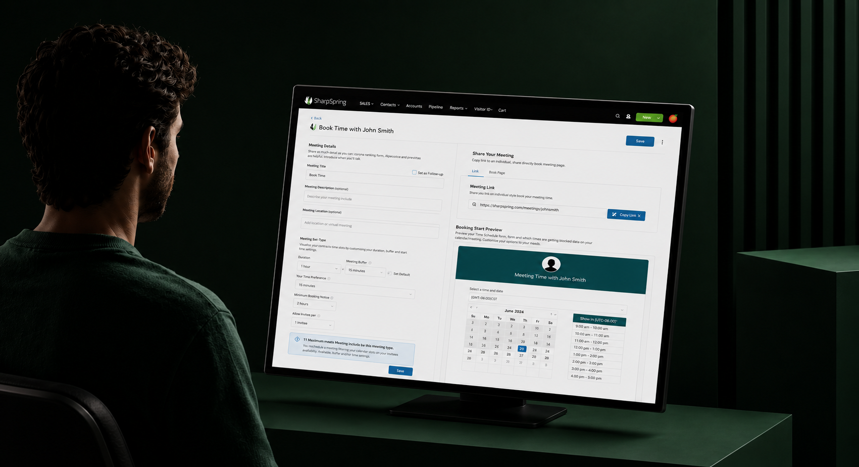 SharpSpring's 'Book Time with John Smith' meeting scheduler on a desktop monitor